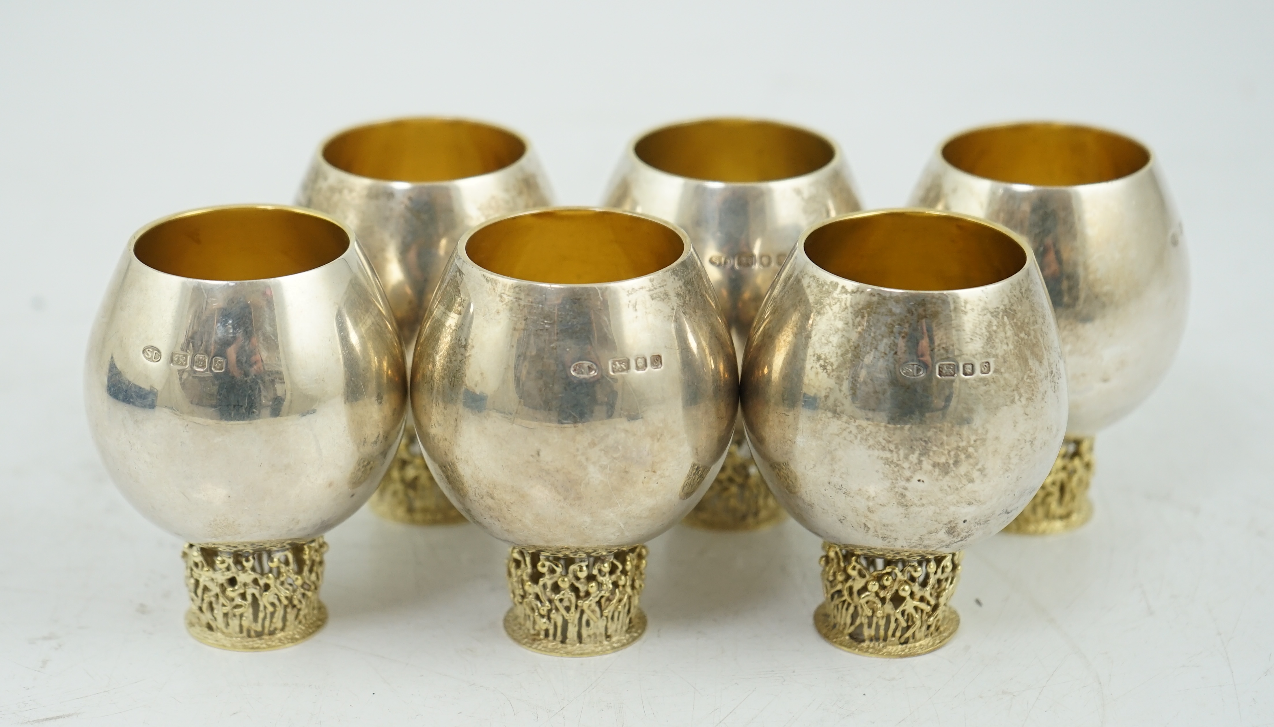 A set of six Elizabeth II Stuart Devlin parcel gilt silver balloon shaped pedestal tots